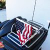 harley davidson motorcycle with 1 motorcycle flagpole with usa flag mounted on the luggage rack and flagpole folded down.
