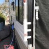 RV toy hauler with ramp flagpole mount and telescoping flagpole up close